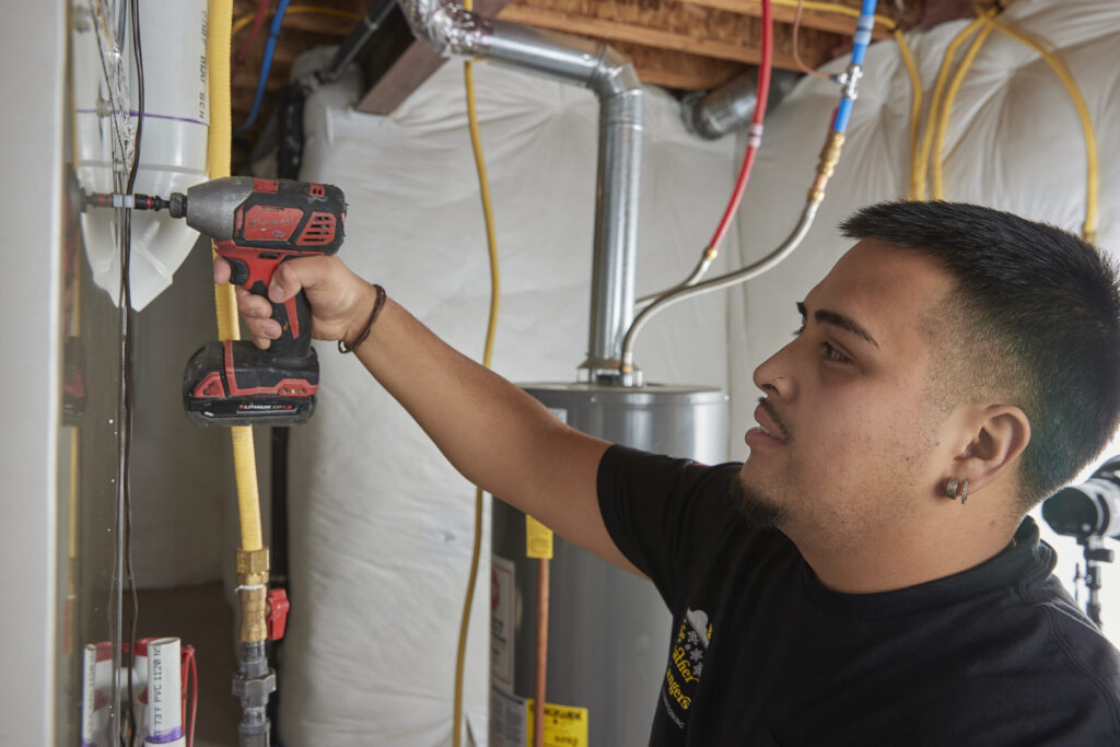 Weather Changers employee installing a residential heating furnace system. 
