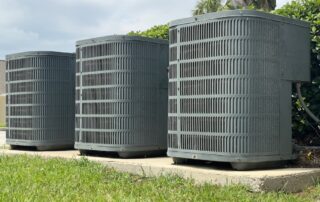 3 HVAC systems side by side installed outside.