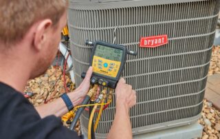 A Weather Changer technician working on a Bryant air conditioning cooling unit.