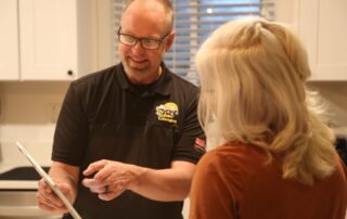 A Weather Changers technician discussing A/C options in Denver, CO.