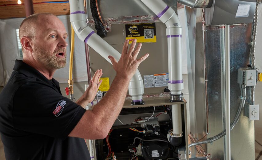 A Weather Changers technician discussing heat pump vs. A/C in Denver, CO.