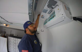 A Weather Changers technician working on a heat pump system in Denver, CO.