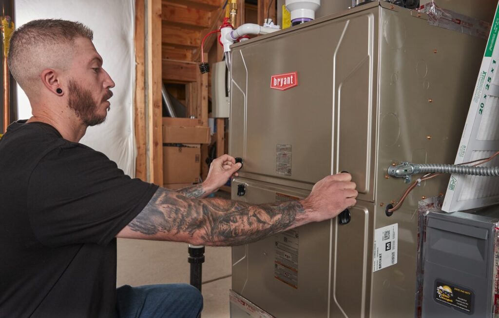 A Weather Changer technician servicing a Bryant furnace. 